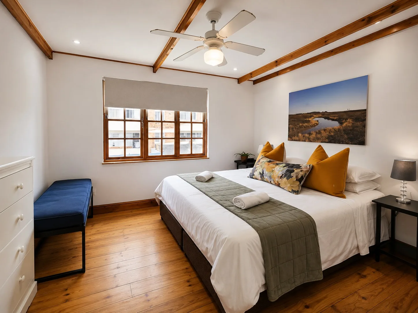 Spacious main bedroom at Loddeys Family Room with a double bed, wooden floors and exposed ceiling beams