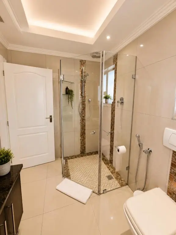 with Glass ShowerModern Ocean Walk bathroom with a spacious glass shower enclosure, mosaic tiles and recessed lighting