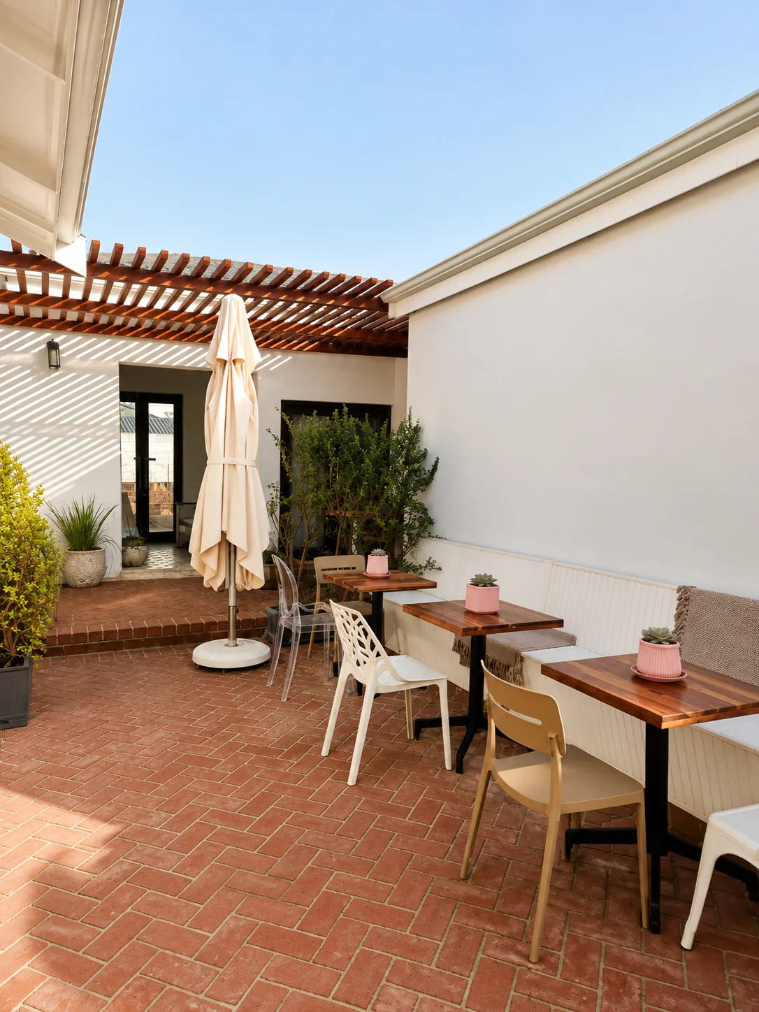 Bright restaurant courtyard with outdoor tables, chairs and covered patio seating